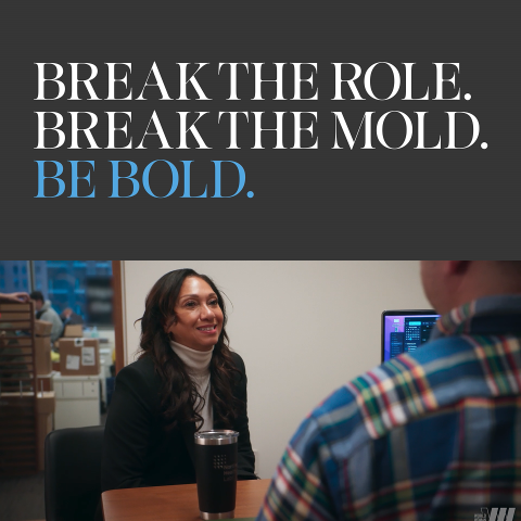 Close-up portrait of a woman smiling against a neutral studio background.