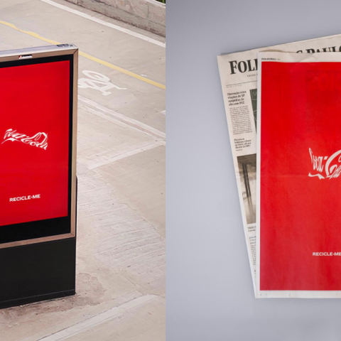 Red Coca-Cola Recycle Me digital ad standing on a city street viewed from a slight angle.
