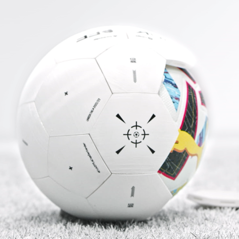 Close-up of LaLiga football resting on artificial turf showing panel detailing and targeting graphic.