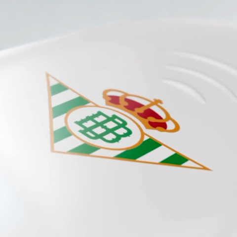 Close-up detail of the Real Betis Balompié crest printed on the club’s white and green football shirt.