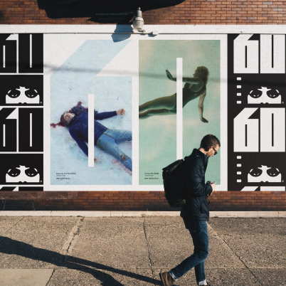 Series of Chicago International Film Festival posters displayed on a brick wall, using bold “60” typography and film still imagery.